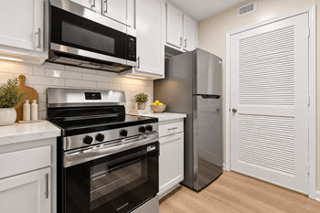 Modern kitchen with stainless steel appliances and white cabinetry